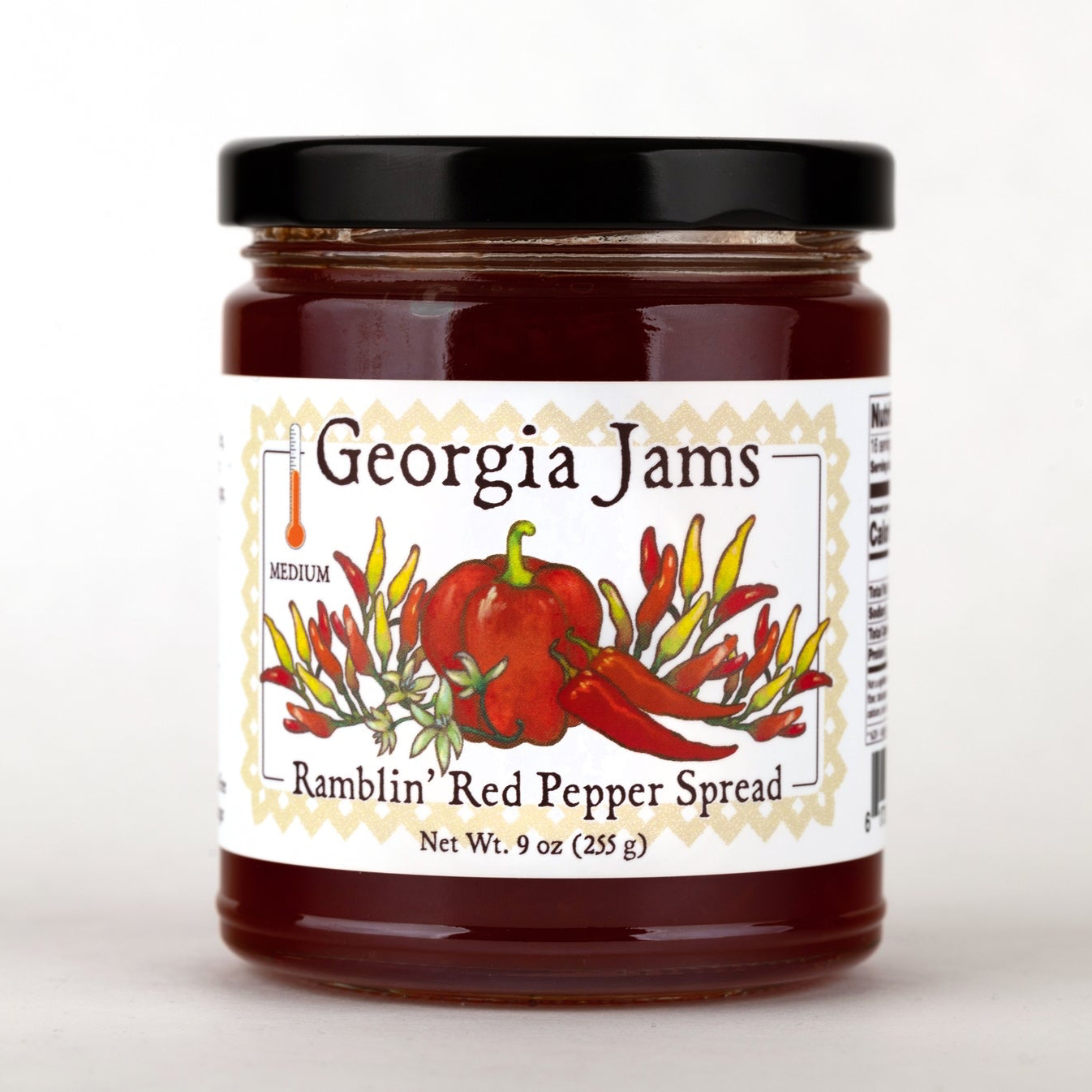 A jar of Ramblin' Red Pepper Spread by Georgia Jams with a label depicting red bell peppers and decorative elements.