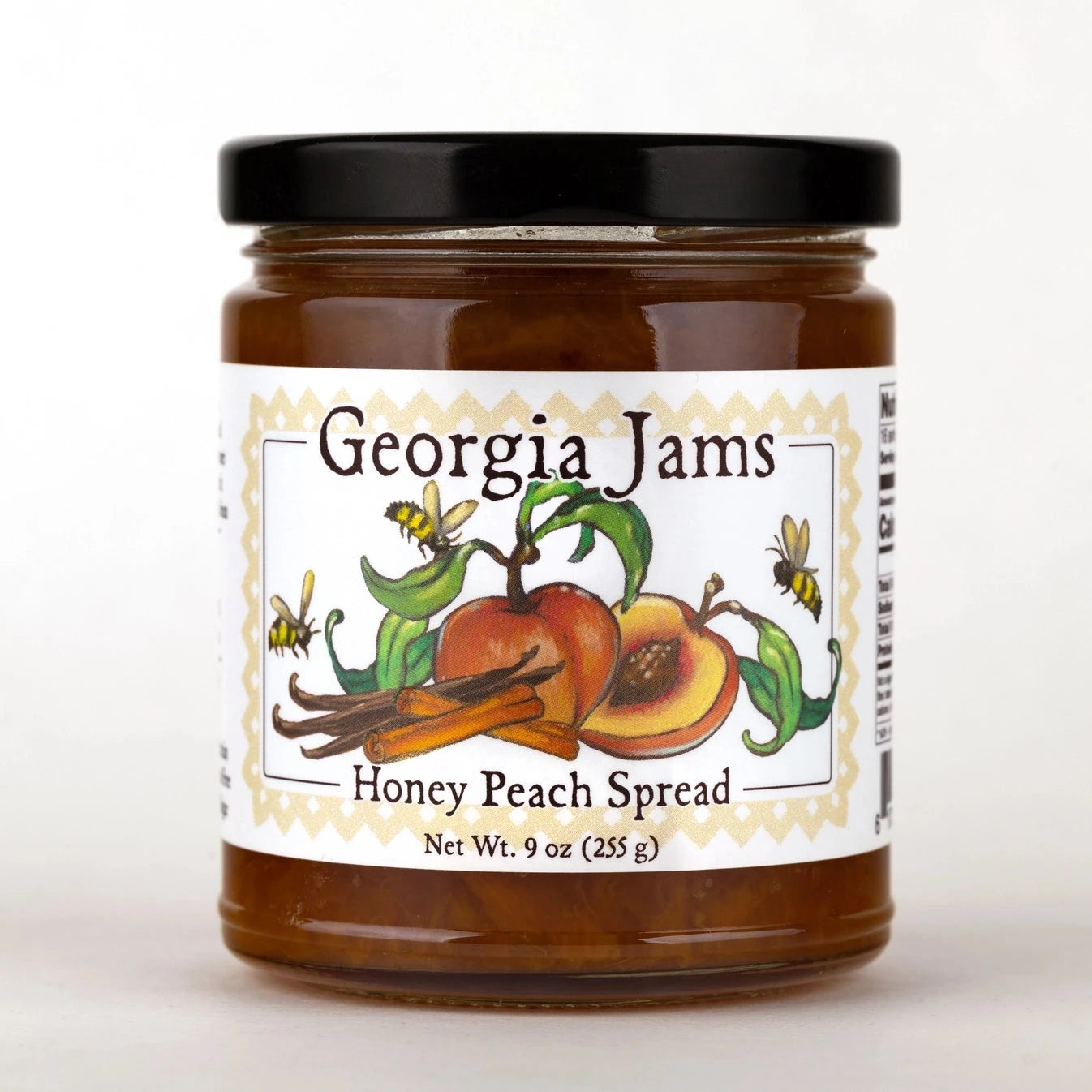 A jar of Honey Peach Spread with a label depicting a peach, vanilla bean, and bees. The brand 'Georgia Jams' is written on the label.