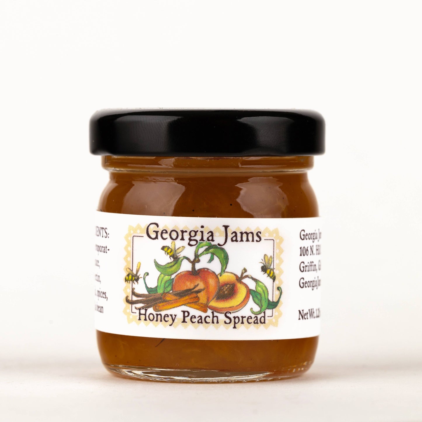 A jar of Georgia Jams Honey Peach Spread with a label showing peaches and the name of the product.
