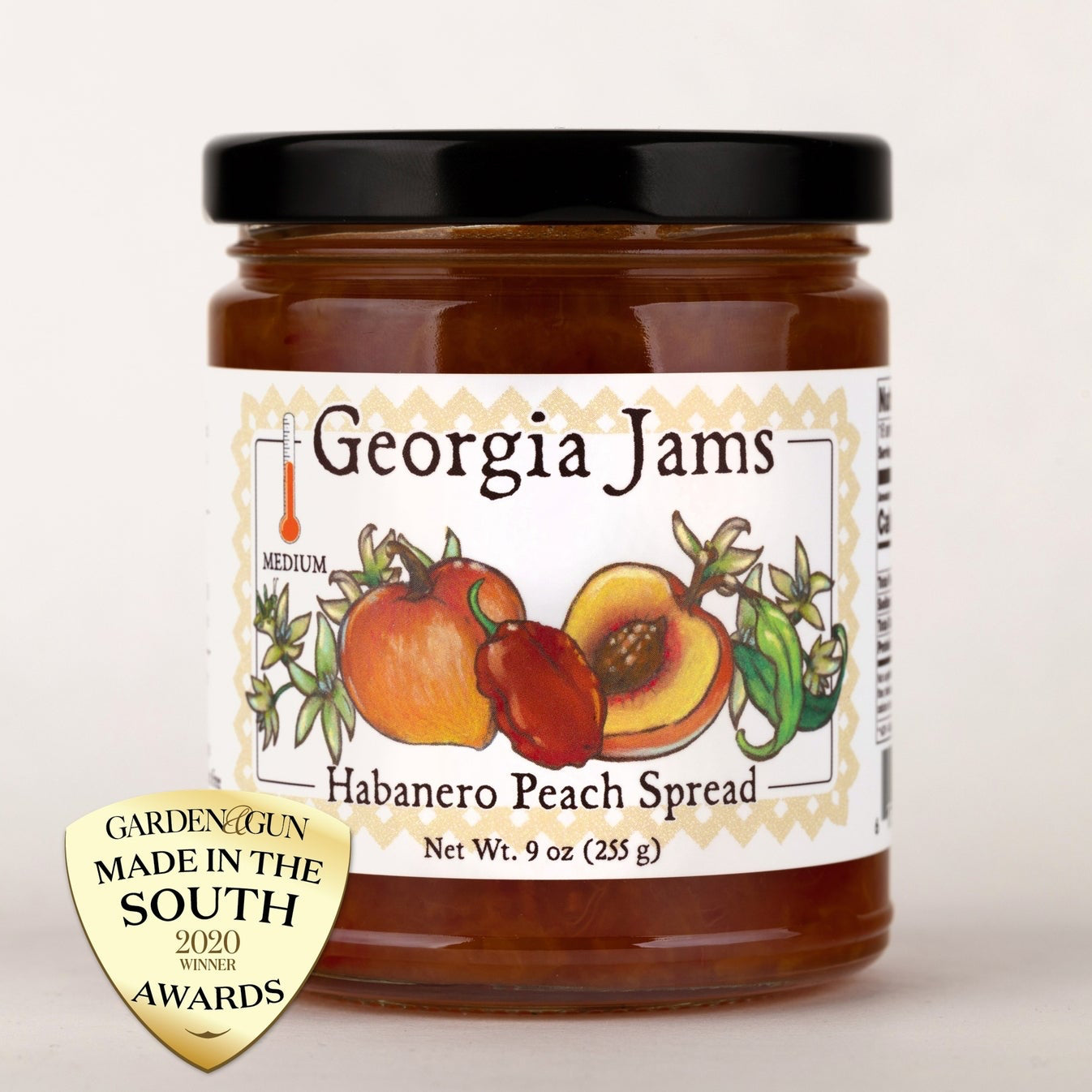 A jar of Habanero Peach Spread from Georgia Jams, with a label depicting peaches and ahabanero pepper, indicating a spicy-sweet condiment.