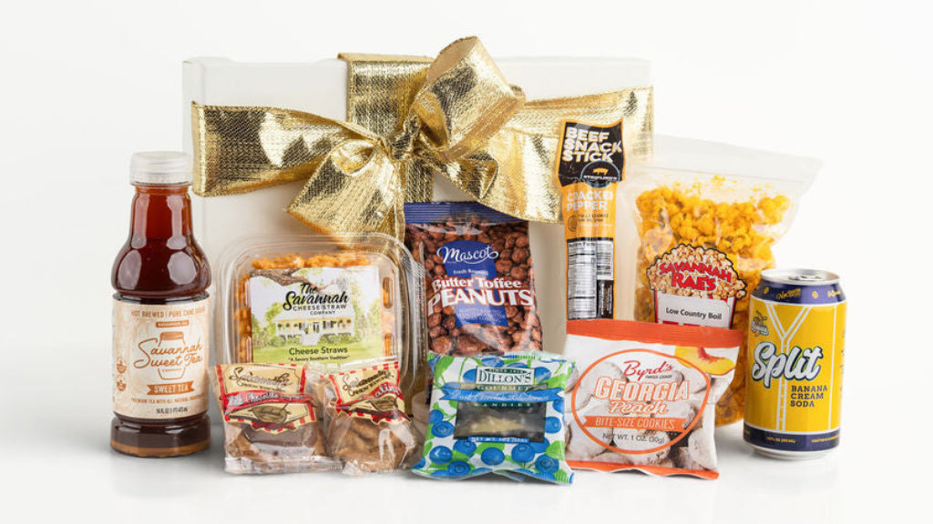Gift basket with various snacks and drinks on a white background